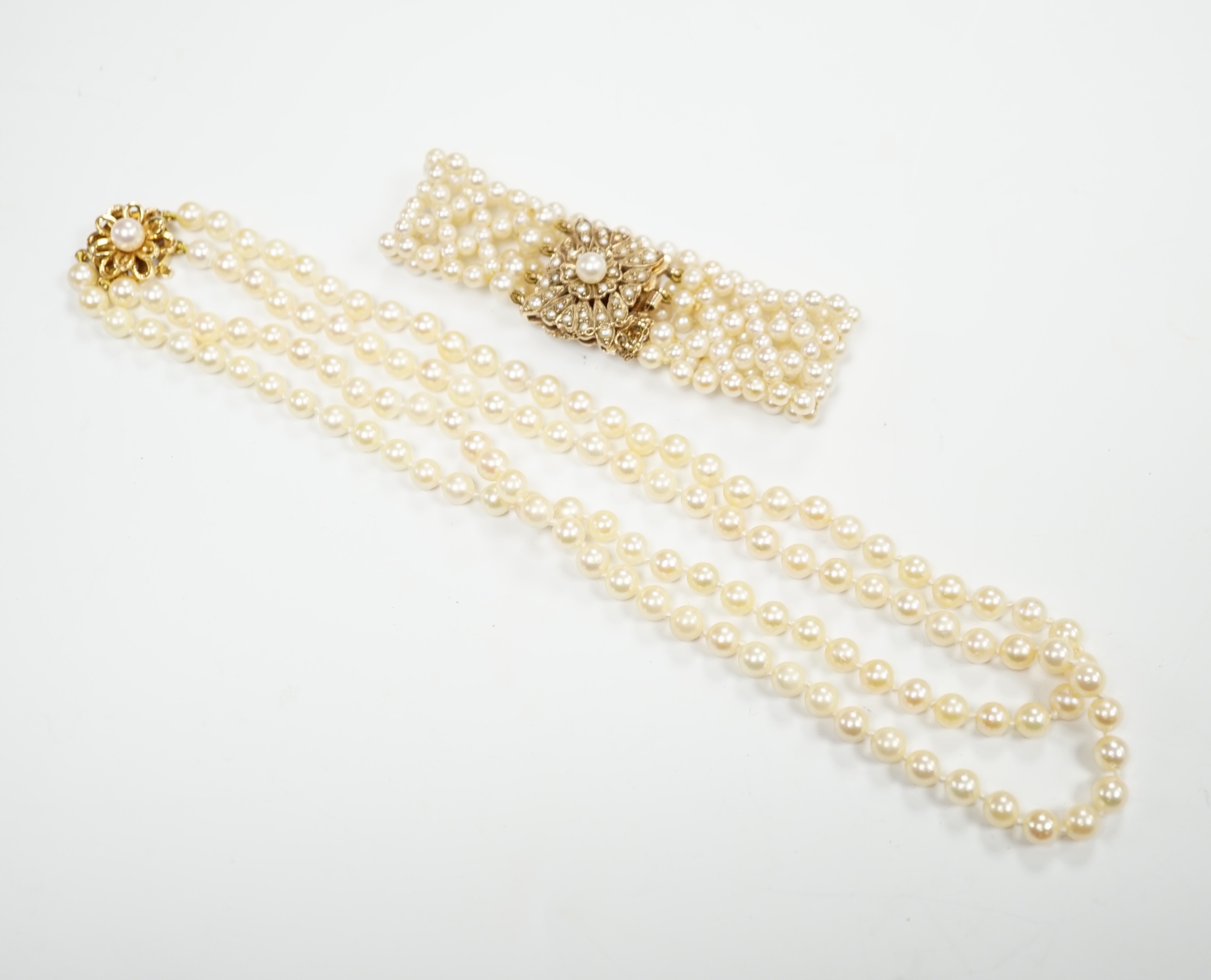 A cultured pearl cluster set bracelet, with seed pearl cluster set 9ct clasp, 16cm, and a similar double row choker necklace, with 9ct clasp, 38cm.